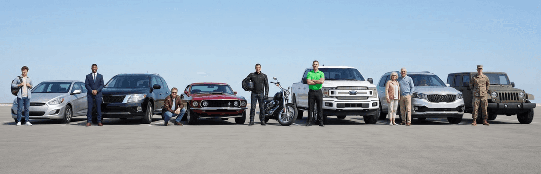 Students, families, a soldier and dealers standing beside their cars, SUVs and motorcycles in a row