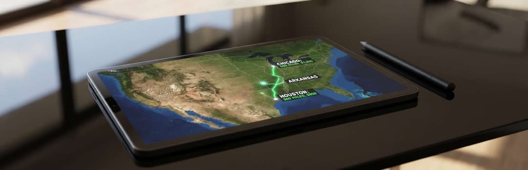 Tablet on a desk displaying a satellite map of the United States with a highlighted shipping route