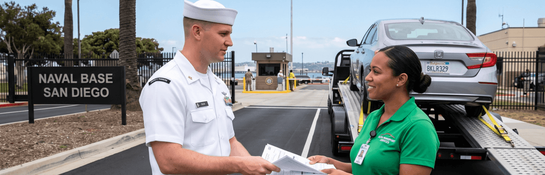Navy sailor at the Naval Base San Diego gate reviewing paperwork with a transport agent beside a loaded car